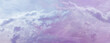 Beautiful romantic pink blue ethereal cloudscape panoramic banner - wide sky line panorama with a romantic pale pink and purple blue puffy cloud stream 

