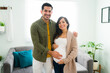 © AntonioDiaz - Happy hispanic husband and wife expecting their first baby