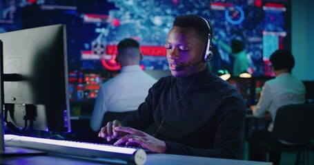 Wall Mural - Cheerful African American man working in high tech security center