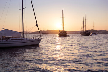 Wall Mural - Sunset over a marina in Bodrum, Turkey. Luxury summer adventure, active vacation in Aegean and Mediterranean sea, Turkey.