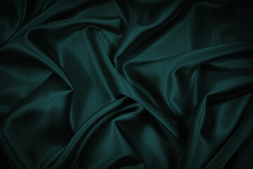 Wall Mural - Black blue green abstract background. Dark green silk satin texture background. Beautiful wavy soft folds on the surface of the fabric. Teal elegant background with copy space for design. Web banner.
