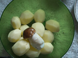 Fototapeta Młodzieżowe - Boletus mushroom on the background of fresh potatoes ready for cooking.