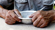 © Stanislau_V - Hungry. Poor old man's hands an empty bowl. Selective focus. Poverty in retirement. Alms