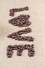 Wall Mural - The coffee beans used to spell inscription love and a heart on hessian sack, Love coffee concept.