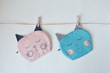 Wall Mural - Cute handmade cat pouches over white	