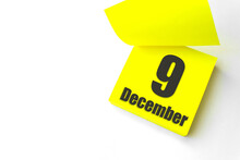 December 9th. Day 9 Of Month, Calendar Date. Close-Up Blank Yellow Paper Reminder Sticky Note On White Background. Winter Month, Day Of The Year Concept.