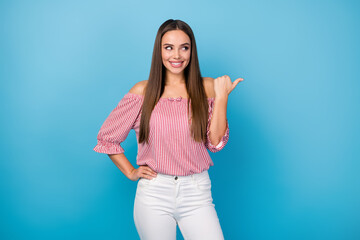 Canvas Print - Portrait of cheerful girl point forefinger copyspace indicate ads discount wear red outfit isolated over blue color background