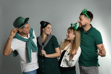 Wall Mural - Happy people in St Patrick's Day outfits on light grey background