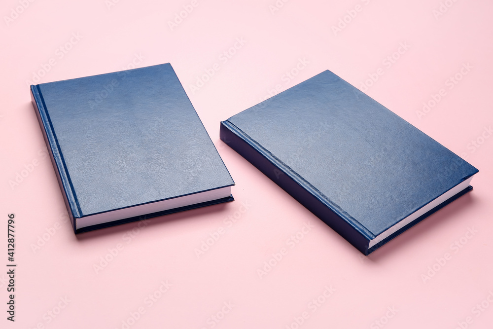 Blank books on color background