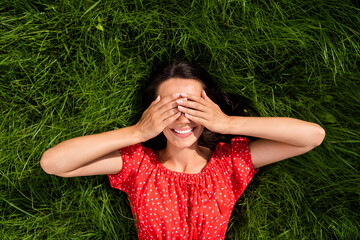 Poster - Photo of childish cute young lady wear red off-shoulders dress resting green grass arms cover eyes outside countryside