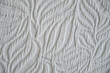© Alena Mostovich - the texture of a dense beige fabric with an ornament. background for the design. window curtains.