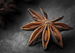 star anise on a dark background along with vanilla