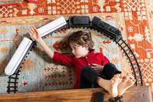 Overhead View Of Young Boy Playing With His Train