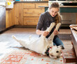 © Mint Images - Teenage girl caressing her English Cream Golden Retriever dog
