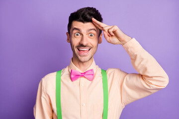 Photo of funny charming young guy wear yellow shirt arm head showing v-sign isolated violet color background