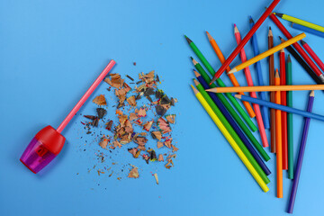 process of sharpening pencil on a blue background