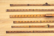 © Formatoriginal - Group of Old wooden ruler on table. Measuring or accuracy concept