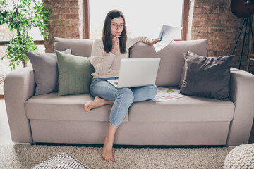 Sticker - Photo of serious focused woman hold paperwork hand chin look laptop remote work inside home indoors house