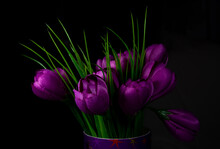 Artificial Purple Flowers On A Black Background