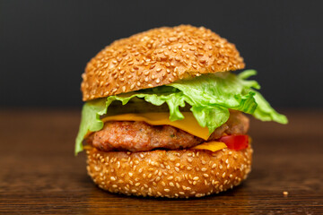 Homemade burger. Isolated on a wooden table.