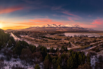 sunset over the sub-Tatra town of Svit with the river Poprad