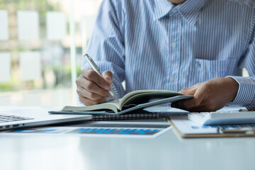 Businessman working at office with documents on his desk, doing planning analyzing the financial report, business plan investment, finance analysis concept