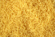 Dry uncooked vermicelli pasta as a background.