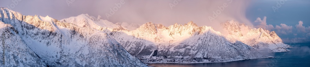 Panorama of snow mountain range with sunshine in the morning at Senja Island - obrazy, fototapety, plakaty 