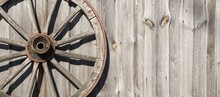Wooden Background Old Wooden Wheel On The Wooden Wall. Village,  Ranch