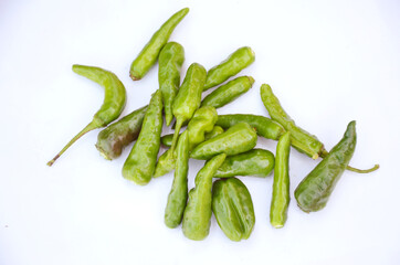 Wall Mural - Bunch of green ripe chili peppers isolated on white background