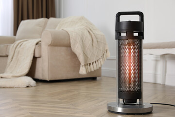 Poster - Modern electric heater on floor at home. Space for text