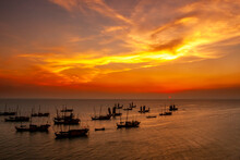 Scenic View Of Fishing Boats At Sea Against Sky During Sunset