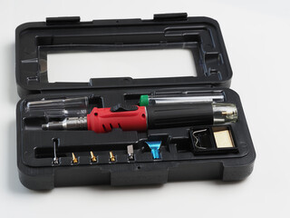 red gas soldering iron in black plastic box