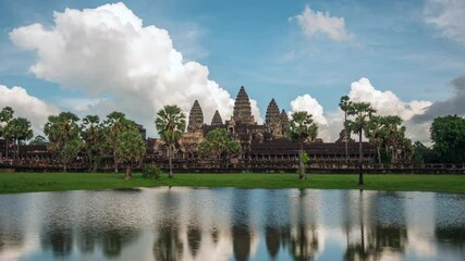 Wall Mural - Siem Reap, Cambodia, zoom in timelapse view of dramatic skies over the ancient ruins of Angkor Wat temple.