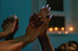 © Svitlana - Romantic evening. Cropped shot of a passionate mixed race couple, man and woman holding hands while having sex in bedroom with candles on the background