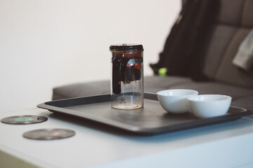 
two cups for tea on the background of a teapot with a plunger