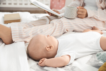 Wall Mural - Mother with little baby sleeping on bed at home