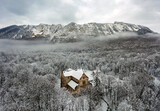 Aerial landscape from Hungar in Bukk Mountains. Scenic view about the Belko mountain andy Belapatfalva town's Cistercian abbey in winter time which coverd fresh snow