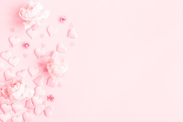 valentine's day background. frame made of pink flowers, hearts on pastel pink background. valentines