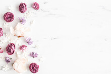 Flowers Composition. White And Purple Flowers On Marble Background. Flat Lay, Top View