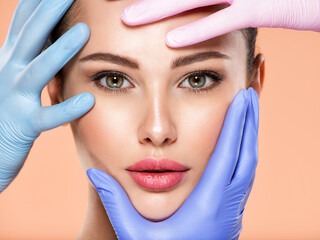Wall Mural - face skin check before plastic surgery. beautician touching young woman face. doctor in medicine glo
