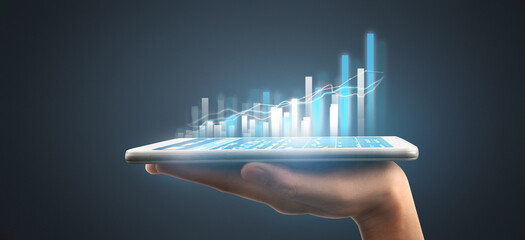 Graph growth and increase of chart positive indicators in his business,tablet in hand