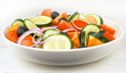 Wall Mural - Mix fresh salad with red tomatoes, cucumber, onion and black olives