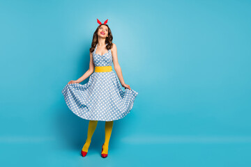 Poster - Full body photo cheerful lovely charming girl enjoy spring rest relax look copyspace touch her retro style polka-dot skirt wear shine tights stilettos headband isolated blue color background