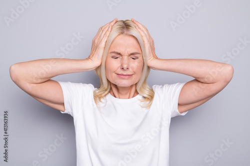 Portrait of blond stressed old lady hands head wear white cloth isolated on grey color background