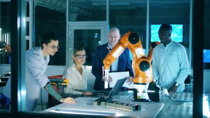 Wall Mural - group of scientists are talking while watching a robot