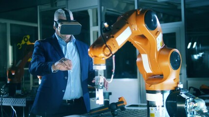 Wall Mural - male scientist is using a vr-device to operate a robot