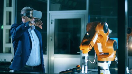 Wall Mural - male researcher is operating a robot in virtual reality