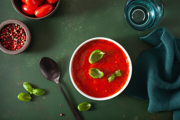 Wall Mural - tomato and bell pepper vegetarian soup on green background