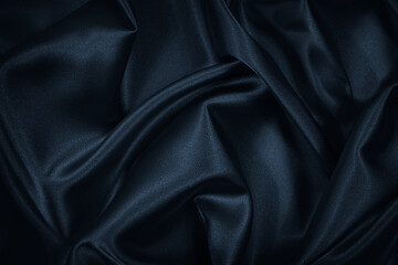 Wall Mural - Black blue abstract background. Dark blue silk satin texture. Beautiful wavy soft folds on the surface of the fabric. Navy blue elegant background with copy space for your design. Web banner.